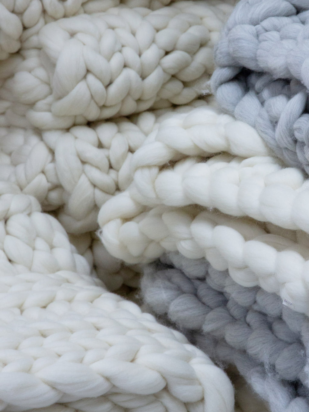 Close-up view of thick knitted fabric with intertwined loops.