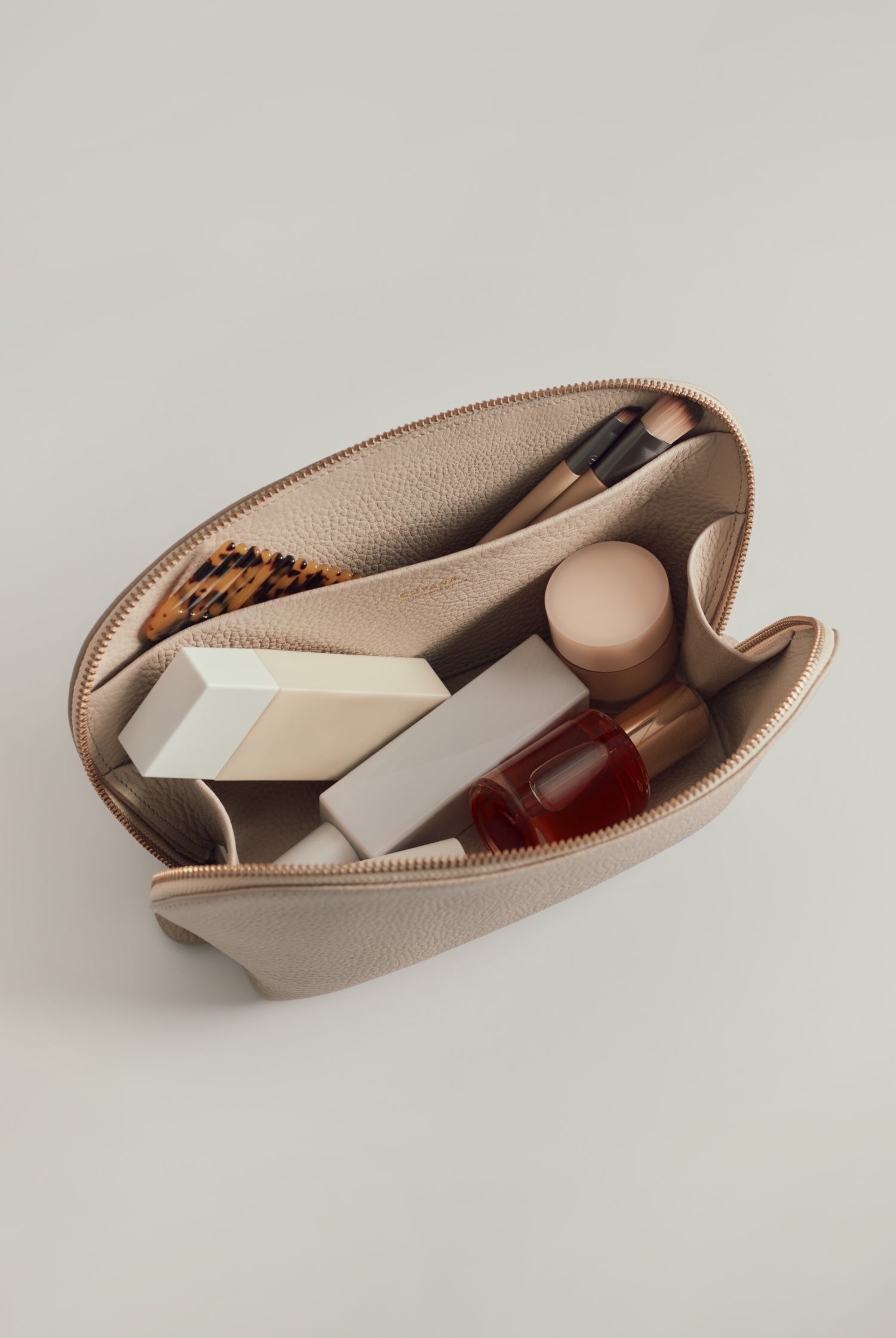 Open zipper bag containing various personal care items.