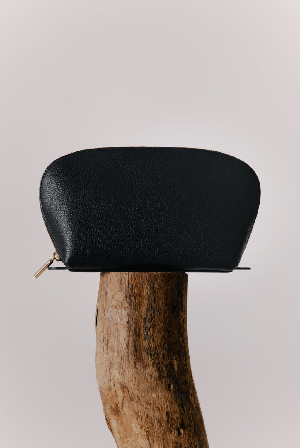Pouch on top of a wooden post.