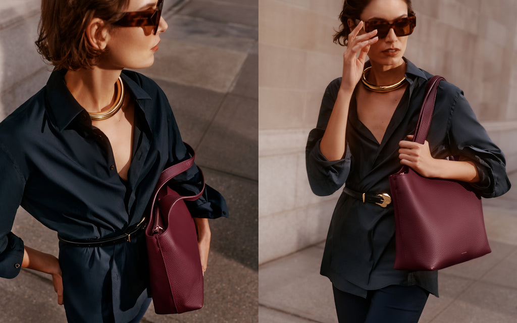 Person wearing a collared shirt with a belt, sunglasses, gold necklace, and holding a tote