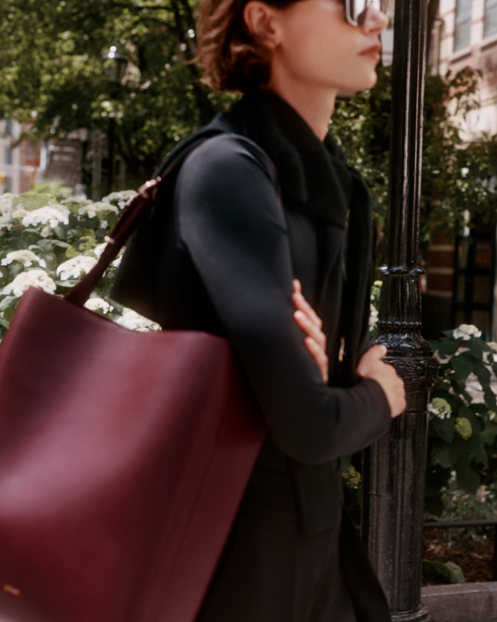 Person walking outside carrying large bag on shoulder
