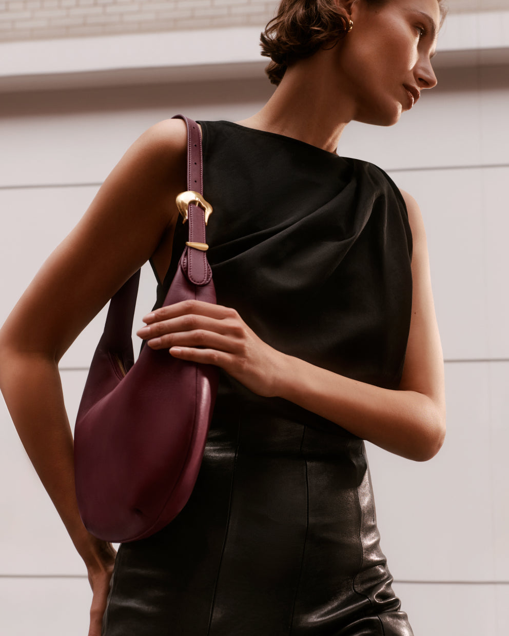 Person holding a bag over their shoulder