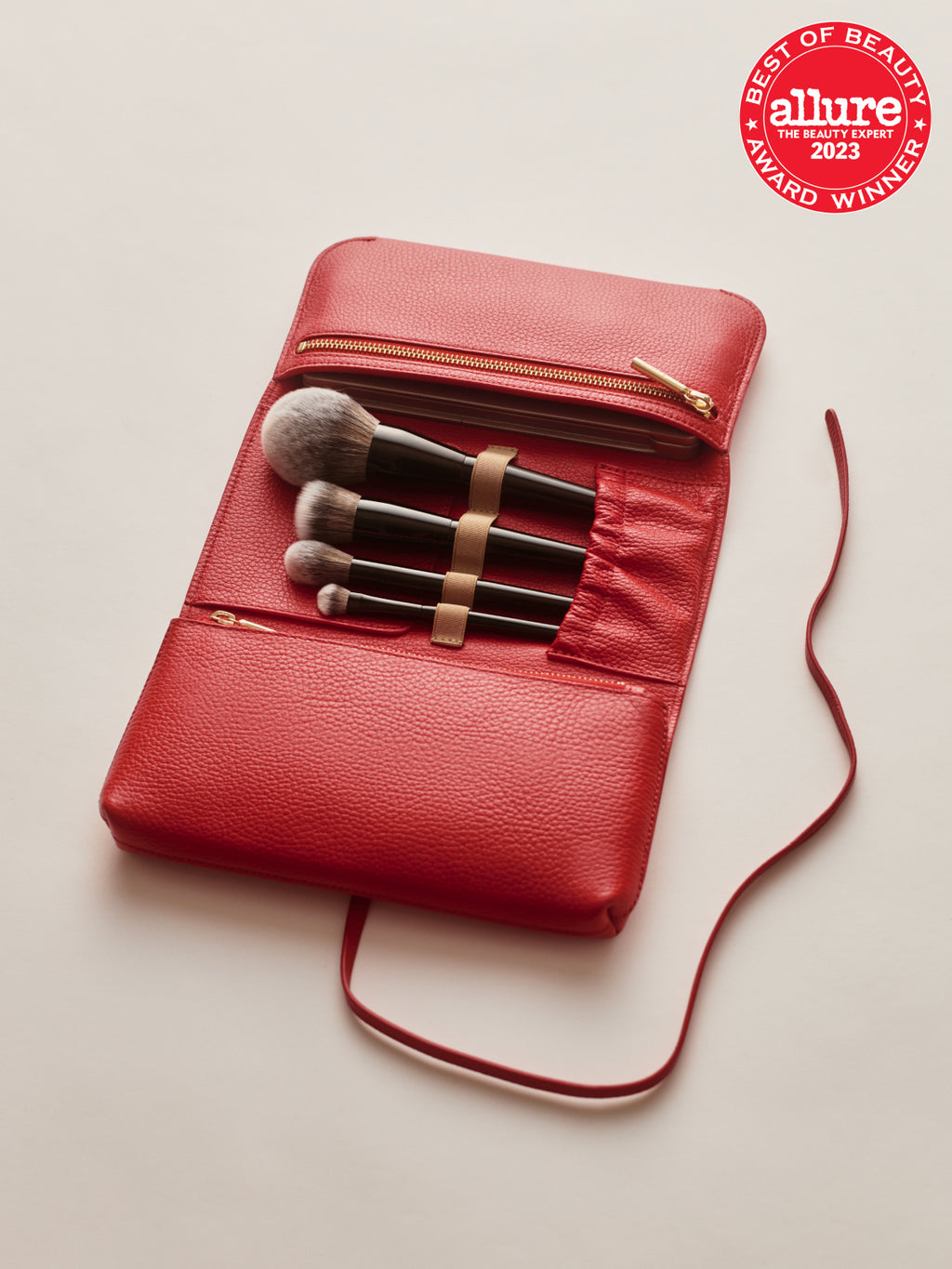 Makeup brushes in a zippered case with Allure award badge on the top right.
