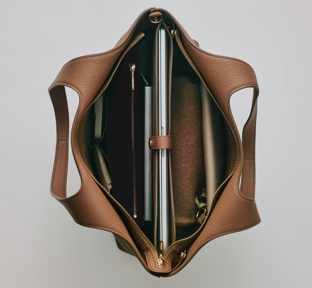 Open tote bag with compartments and contents visible from top view.