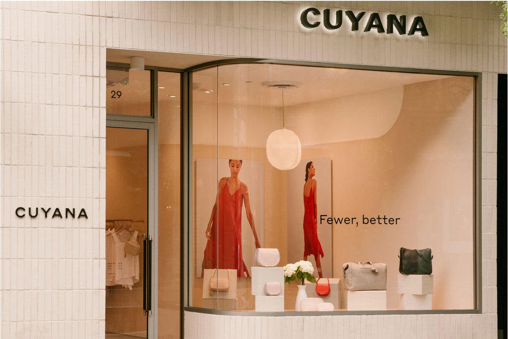 Storefront with mannequins, bags, and minimal decor