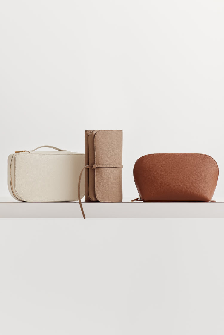 Three different styled bags on a shelf.