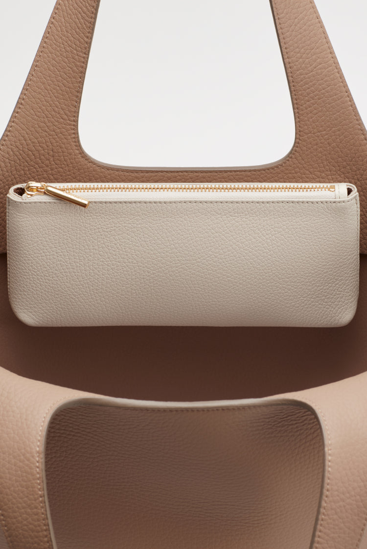 Close-up of a handbag with a zipper pouch