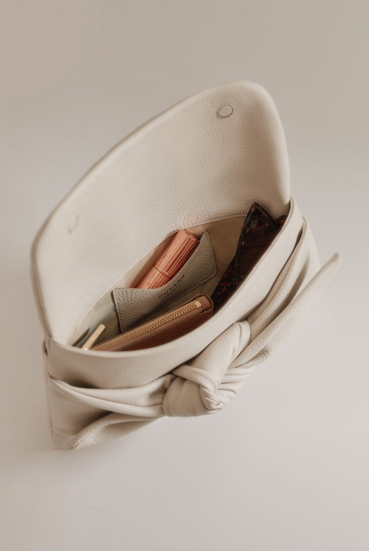 Open handbag with visible contents inside.