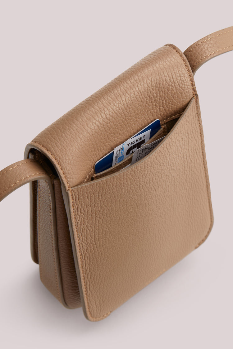 Small purse with a credit card sticking out of an exterior pocket.