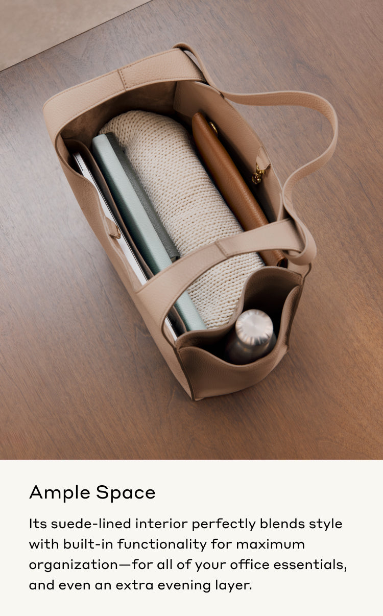 Open handbag with contents organized inside on a wooden surface.