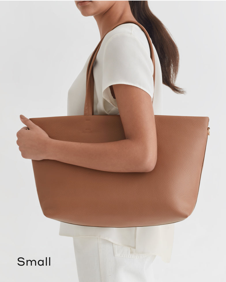 Woman carrying a large tote bag on her shoulder