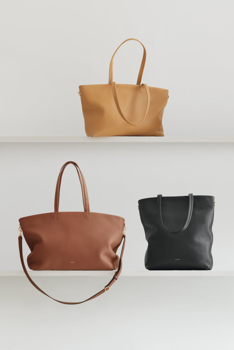 Three bags arranged on two shelves.