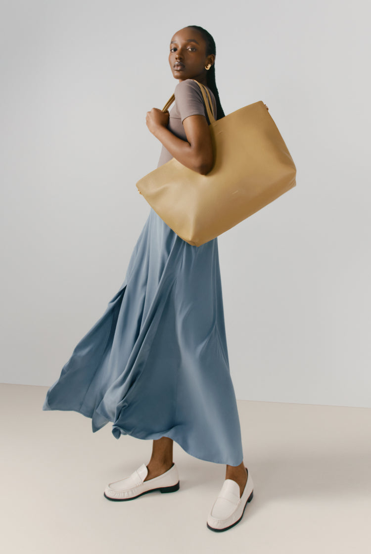 Woman walking with a large bag over her shoulder