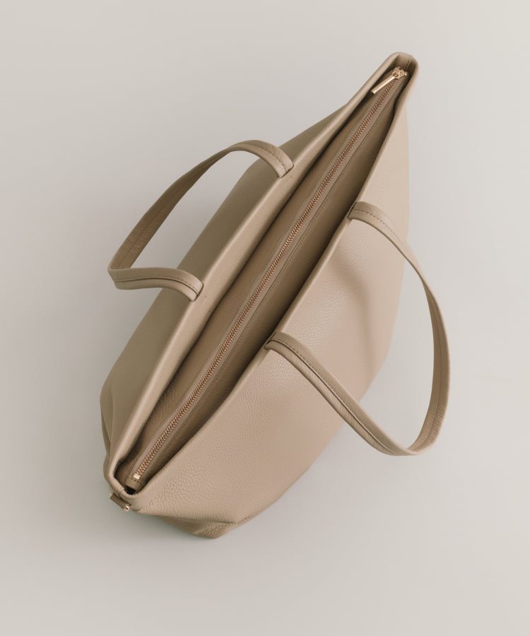 Top view of an open handbag with a single strap.