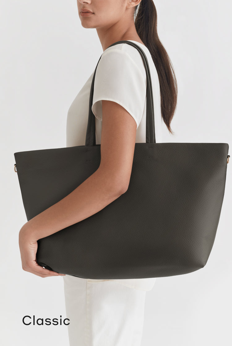 Woman carrying large handbag over her shoulder.