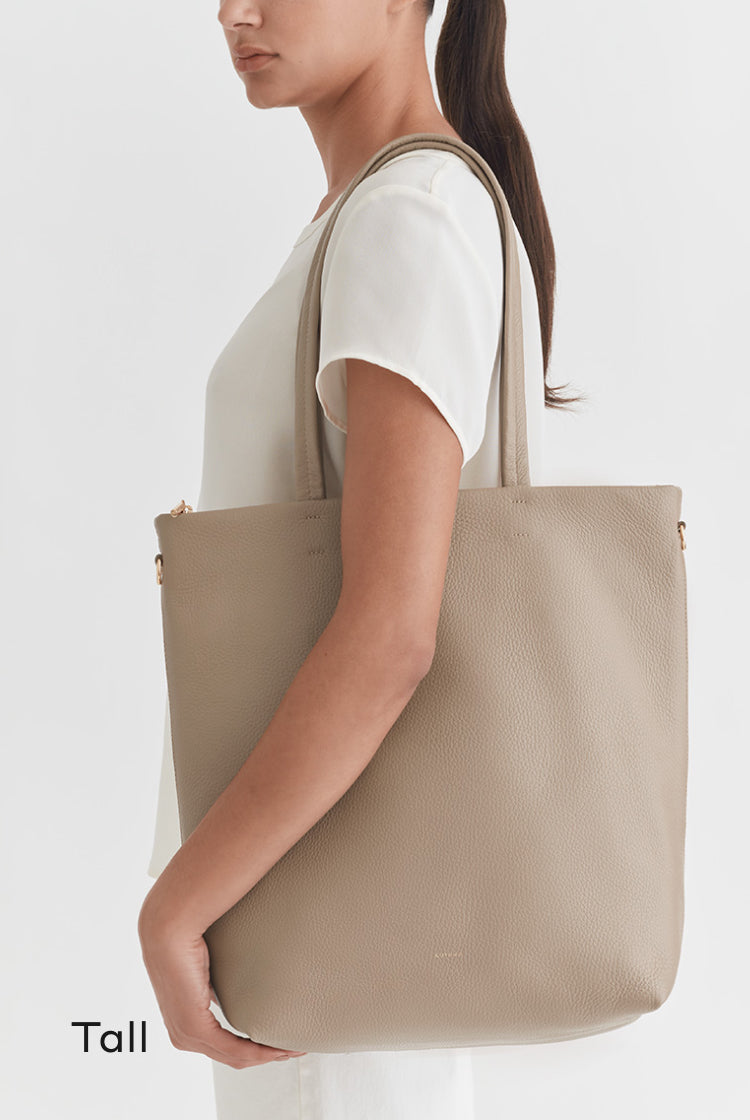 Woman carrying a large tote bag on her shoulder