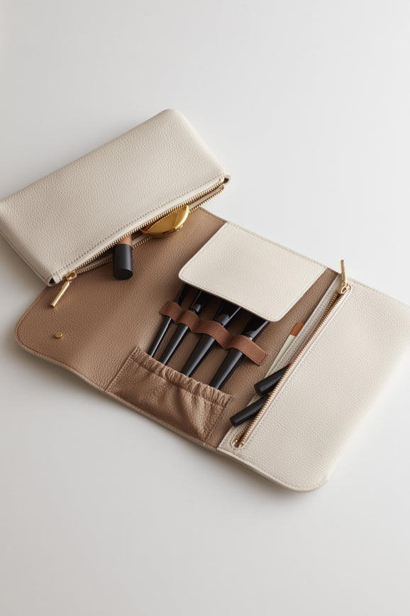 Open organizer clutch with makeup items inside.