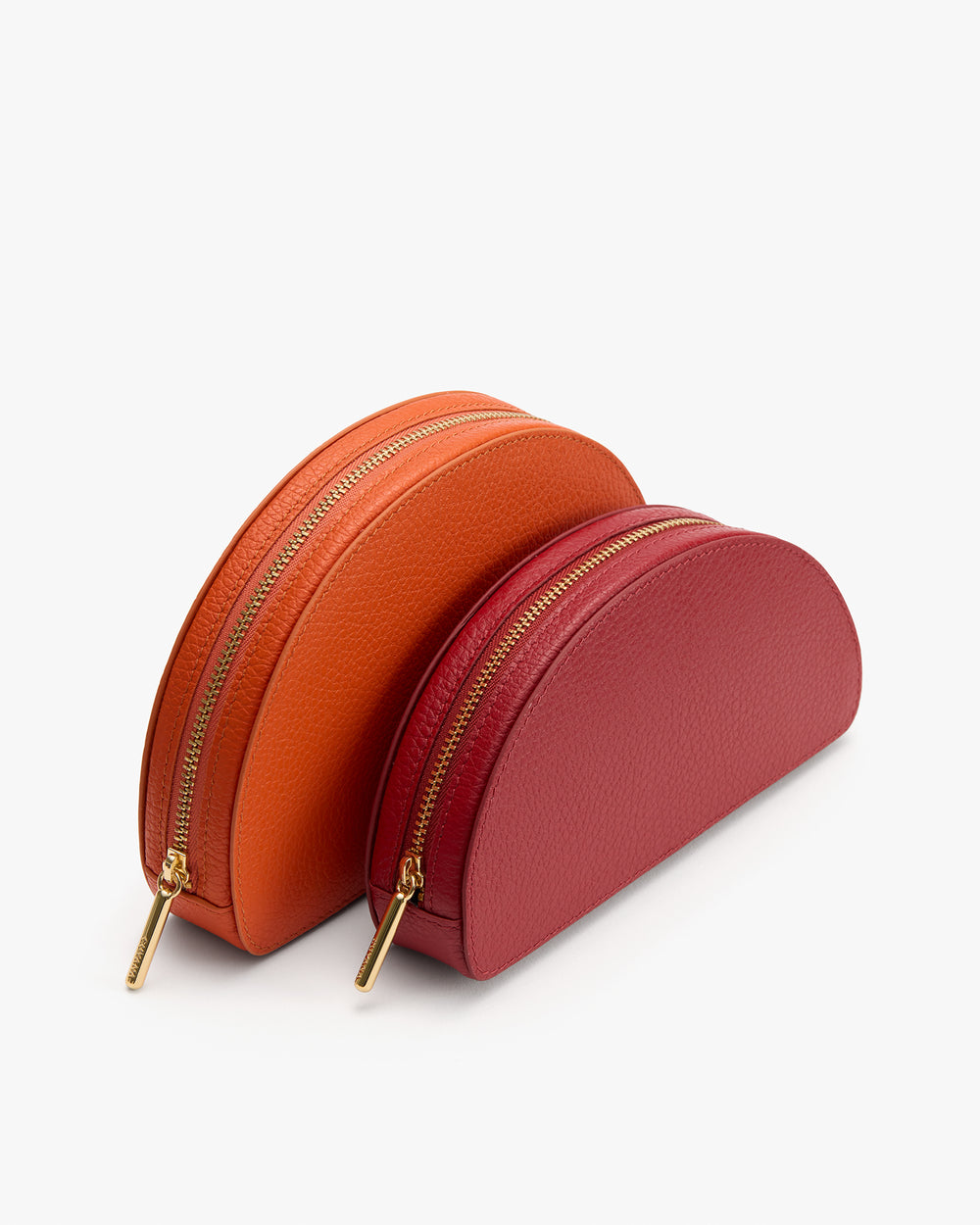 Two semicircular zipper pouches, one larger and one smaller.