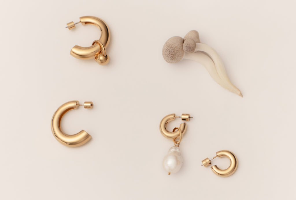 Various earrings displayed on a plain background.