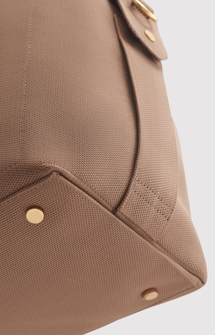 Close-up of a textured bag with metal details.