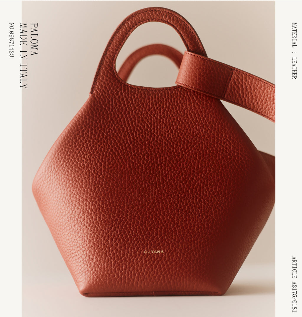 Hexagonal handbag with short handles displayed upright.