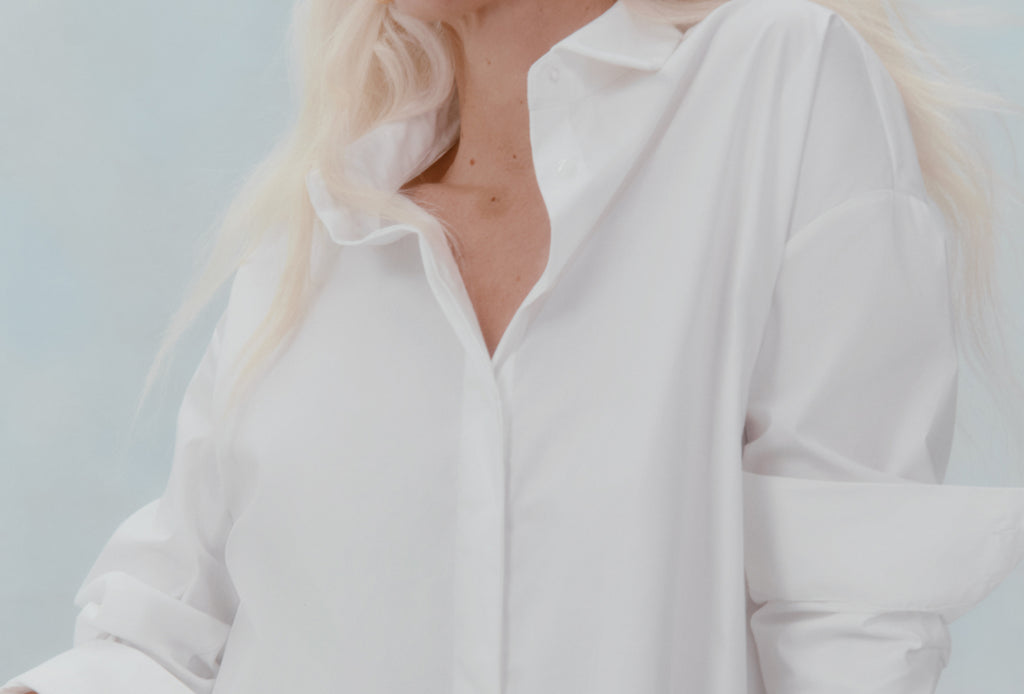 Close-up of a person in a collared shirt with blonde hair.
