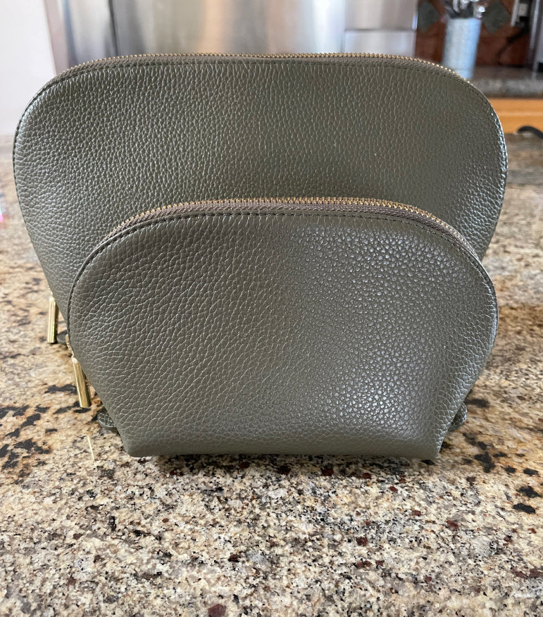 Leather bag on a countertop with a zipper closure.