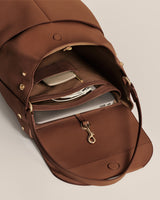 Open backpack with laptop and accessories inside.