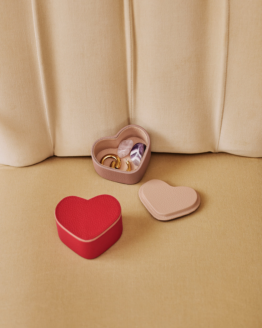 Heart Organizer Case Heart-shaped jewelry boxes on a cushioned background with rings and small items inside.