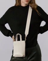 Person with a small crossbody bag over the shoulder