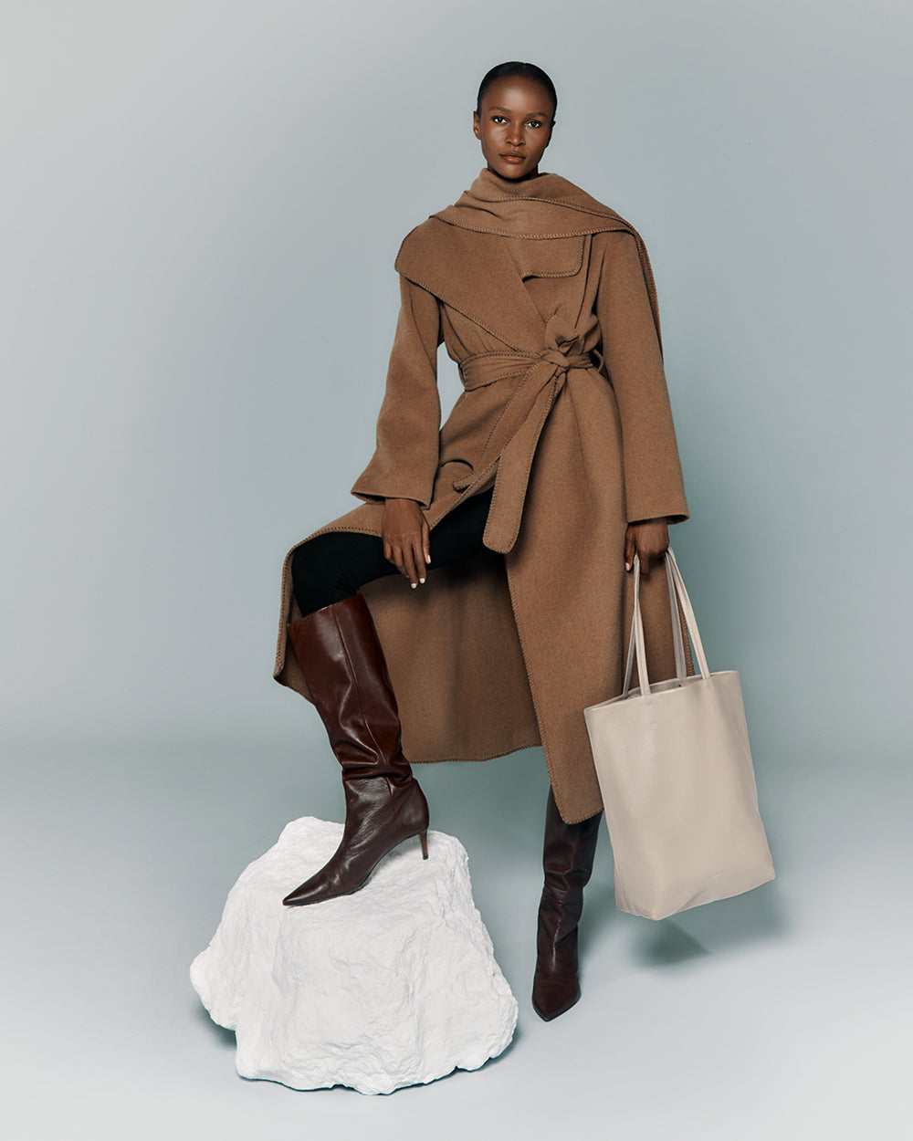 Tall Easy Tote Person in a long coat with boots and holding a large tote bag