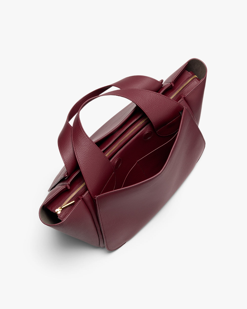 Mila Satchel A dark red handbag with dual handles and multiple compartments, viewed from the top.