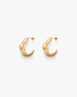 Pair of curved, minimalist earrings displayed on a plain background.