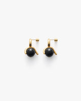 Gold earrings with black round stones.