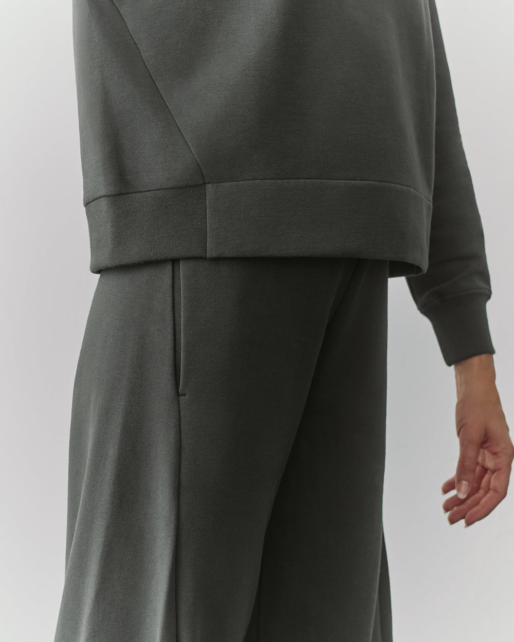 Person in matching top and pants outfit, shown from the waist down.