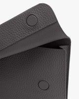 Open textured leather bag with button closures
