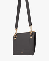 Crossbody bag with adjustable strap and metallic clasps