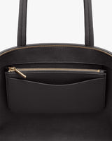 Open handbag with a visible zip pocket and pouch inside