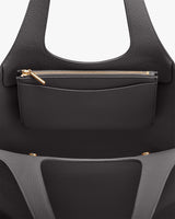 Open handbag with a visible zippered pocket inside