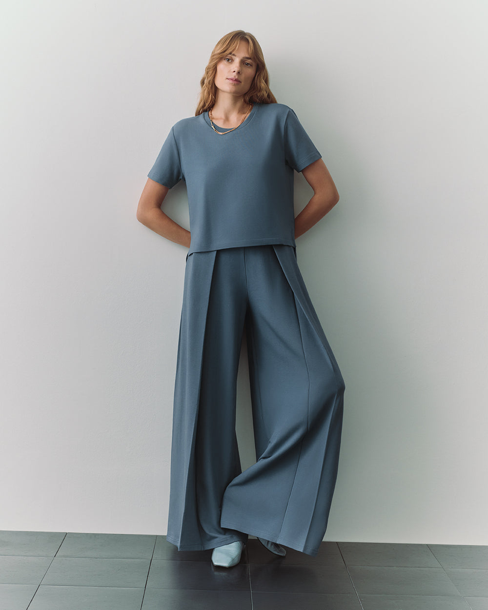 French Terry Cropped Tee Person wearing loose-fitting top and wide-leg pants stands with hands in pockets.