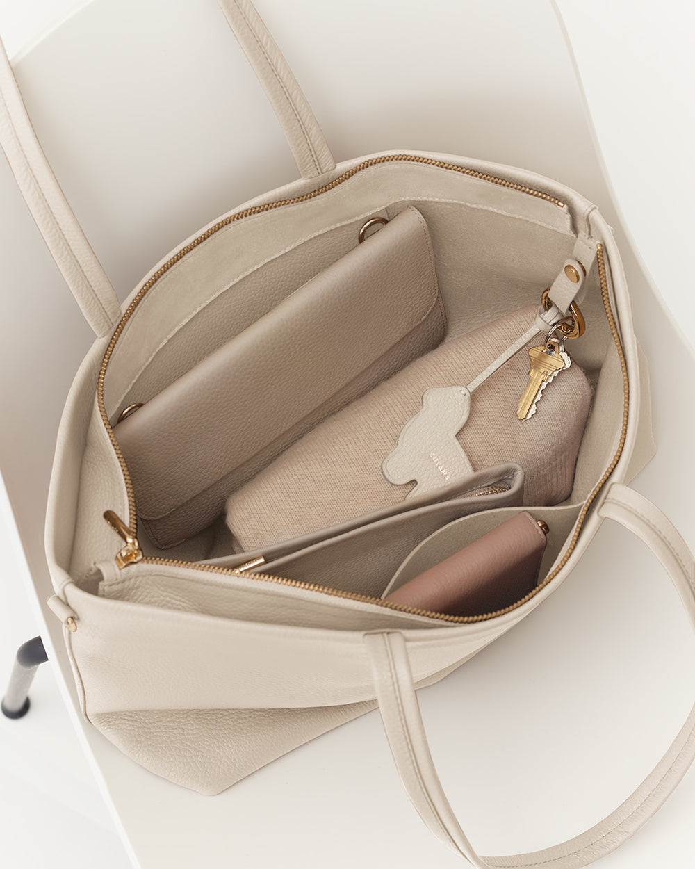 Small Easy Zipper Tote Open tote bag with a wallet, pouch, and keys inside.