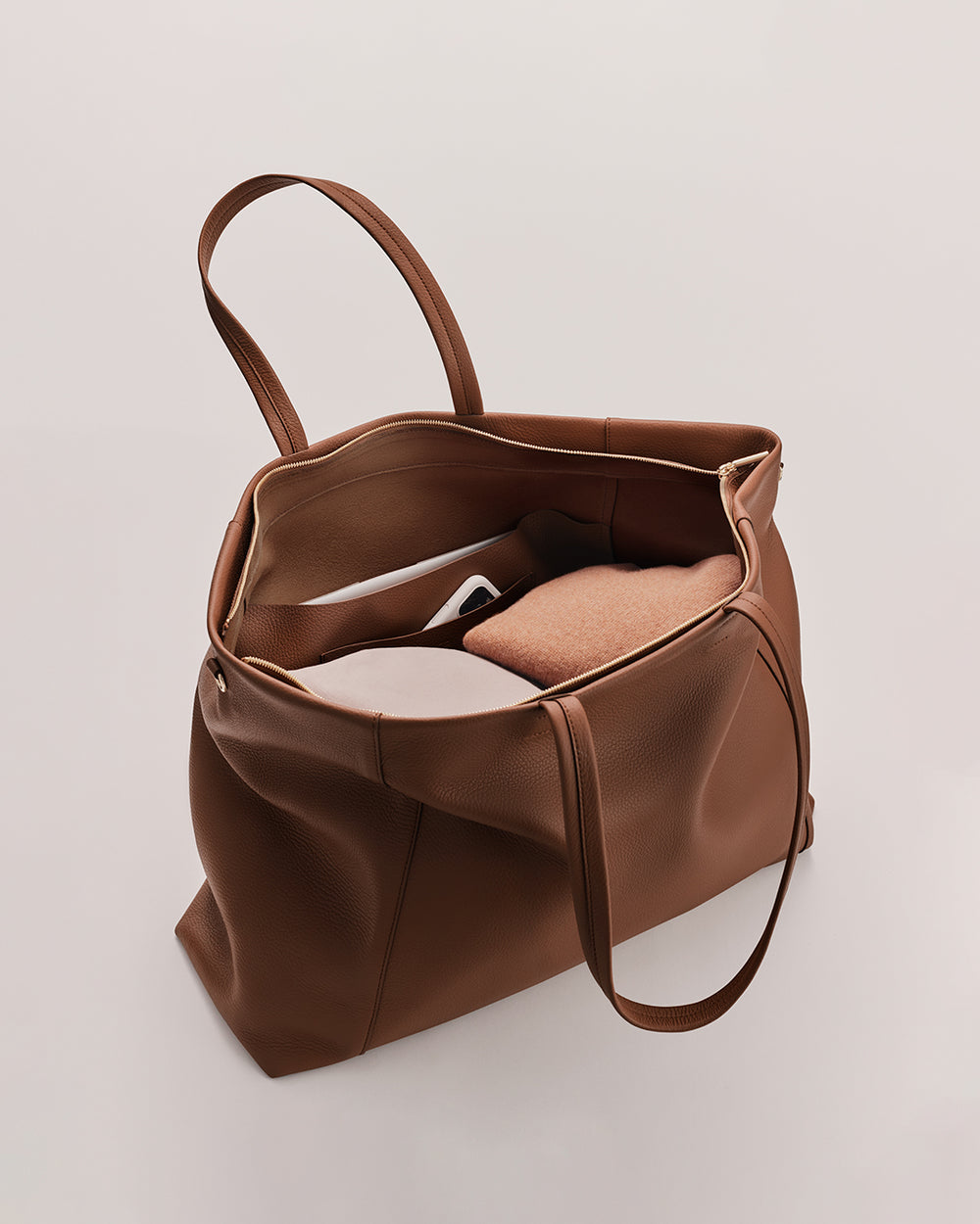 Easy Overnighter Bag Open travel bag with items inside, including a folded piece of clothing.