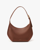 Shoulder bag with a curved base and a buckle on the strap.