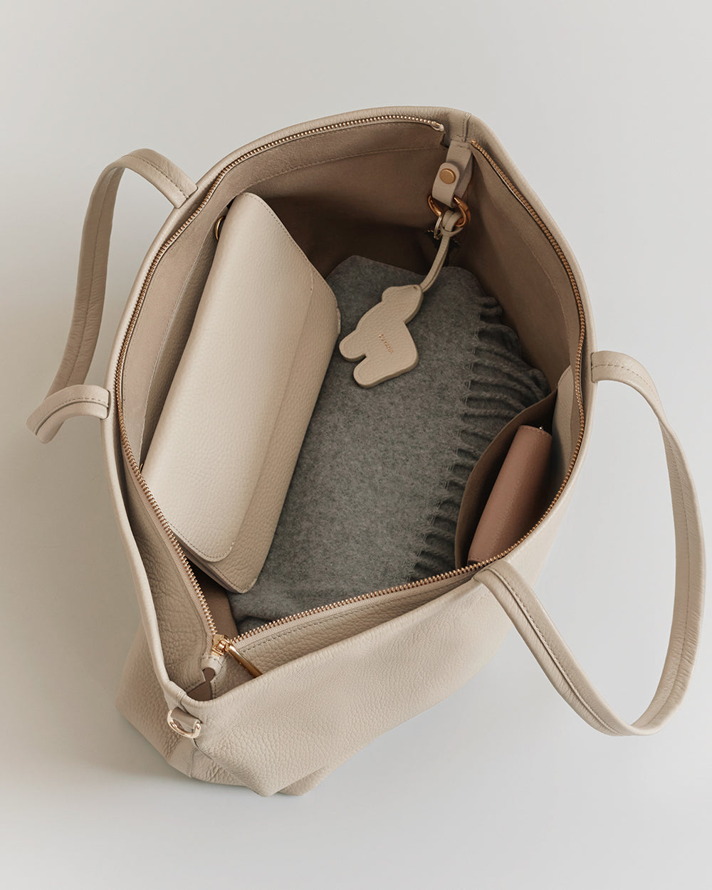 Classic Easy Zipper Tote Open tote bag with a folded sweater, pouch, and a small keychain inside.