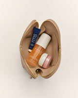 Open travel bag with skincare products inside.