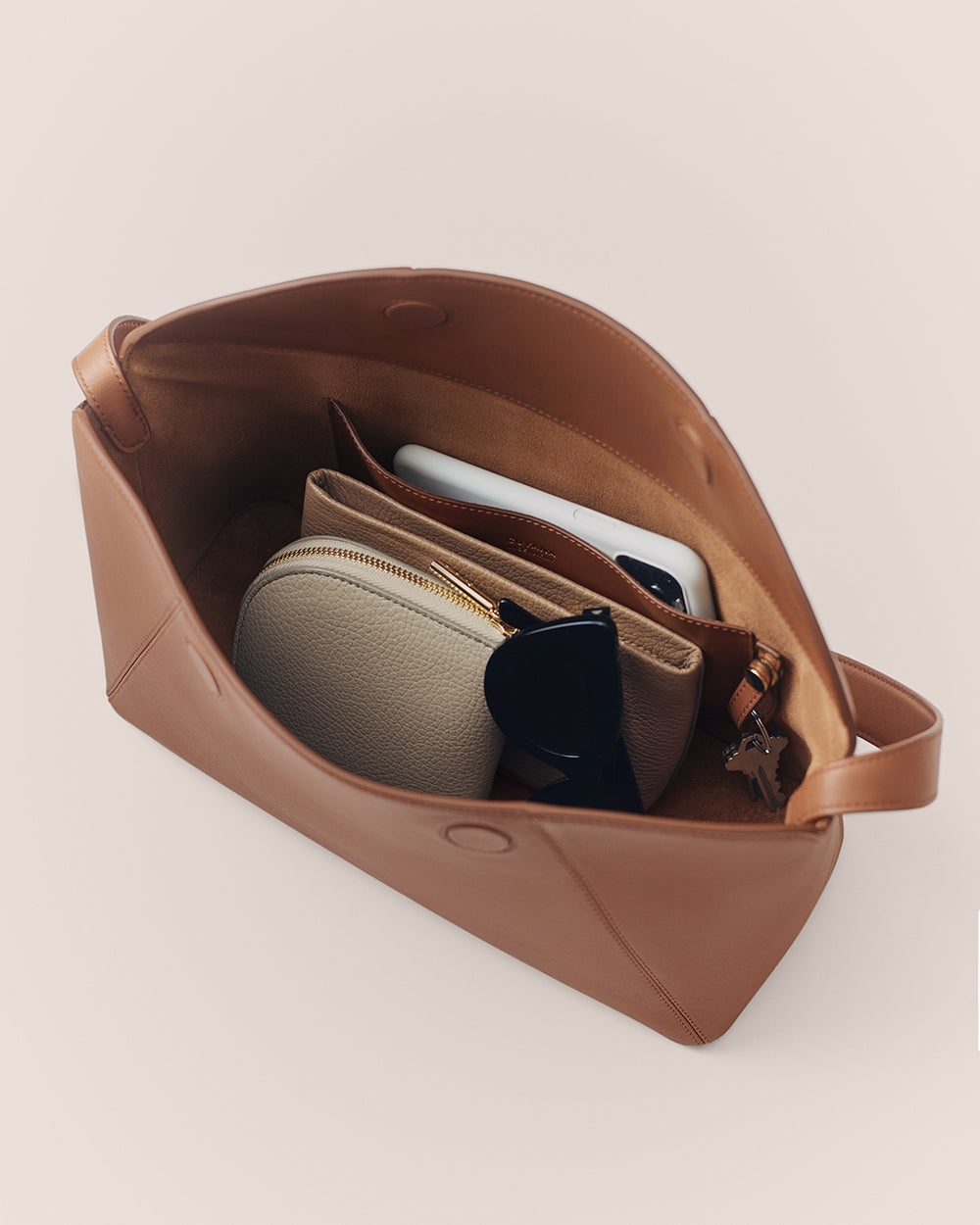 Forma Shoulder Bag Open handbag with wallet, sunglasses, and phone inside.