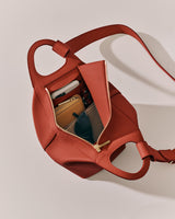 Open bag with sunglasses and small items inside