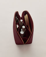 Open toiletry bag with various grooming items inside