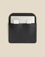 Laptop sleeve with two pockets holding a laptop and cables