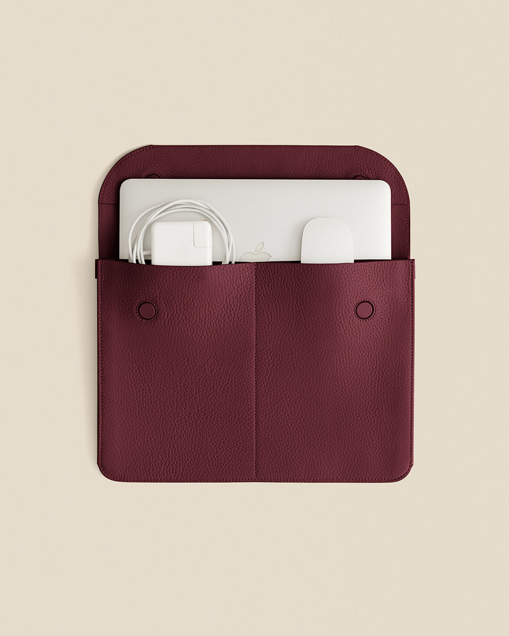 Laptop sleeve with charger and adapter inside pockets.